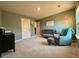 Cozy Bedroom with sage green walls, a dark wood crib, and comfortable gray armchair with floor lamp at 3836 Saddle Hill Way, Douglasville, GA 30135
