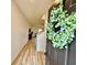 Inviting entryway with wood-look flooring, a staircase, and a decorative wreath on the front door at 3836 Saddle Hill Way, Douglasville, GA 30135