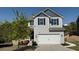 Charming two-story home featuring a two-car garage, landscaped front yard, and modern gray siding at 3836 Saddle Hill Way, Douglasville, GA 30135