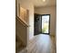 Bright foyer with an open doorway showcasing the home's modern staircase and inviting entry at 3836 Saddle Hill Way, Douglasville, GA 30135
