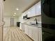 Stylish kitchen features white cabinetry, granite countertops, stainless steel microwave and modern lighting at 3836 Saddle Hill Way, Douglasville, GA 30135