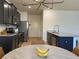 Charming eat-in kitchen featuring stainless steel appliances, gray cabinets and a view to the front door at 3836 Saddle Hill Way, Douglasville, GA 30135