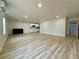 Spacious living room with light wood floors and an adjacent modern kitchen offers a functional layout at 3836 Saddle Hill Way, Douglasville, GA 30135
