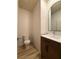 Stylish half bathroom featuring a modern vanity, round mirror, and sleek fixtures at 3836 Saddle Hill Way, Douglasville, GA 30135