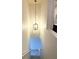 Staircase featuring an elegant chandelier, leading down to lower level, and access to a bathroom at 3836 Saddle Hill Way, Douglasville, GA 30135