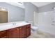 A bathroom featuring tile flooring, a white tub, and a wooden vanity at 5027 Lower Elm St, Atlanta, GA 30349