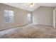 A bright bedroom featuring two windows and neutral carpeting and paint at 5027 Lower Elm St, Atlanta, GA 30349