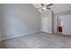 A carpeted bedroom with neutral-colored walls and a ceiling fan at 5027 Lower Elm St, Atlanta, GA 30349