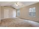 Neutral bedroom featuring multiple windows, neutral carpet and a ceiling fan at 5027 Lower Elm St, Atlanta, GA 30349