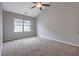 A carpeted bedroom with a large window and neutral colored walls at 5027 Lower Elm St, Atlanta, GA 30349
