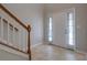 View of the entry foyer featuring tile flooring, sidelights, and a staircase at 5027 Lower Elm St, Atlanta, GA 30349