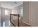 Bright hallway with a modern light fixture and wood and white banister at 5027 Lower Elm St, Atlanta, GA 30349