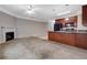 Open floor plan with a fireplace, a ceiling fan, and a kitchen area at 5027 Lower Elm St, Atlanta, GA 30349