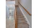 Carpeted staircase with a wooden banister at 5027 Lower Elm St, Atlanta, GA 30349