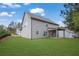 Back exterior view of home with siding, a covered patio, and a spacious lawn at 5414 Splendida Ct, Fairburn, GA 30213
