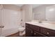 Bathroom with wood floors, granite vanity, and a shower-tub combo at 5414 Splendida Ct, Fairburn, GA 30213