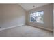 Bedroom with neutral walls, carpeting, and a window with an exterior view at 5414 Splendida Ct, Fairburn, GA 30213