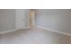 An empty bedroom shows carpeted floors, neutral paint, and access to another room with an open door at 5414 Splendida Ct, Fairburn, GA 30213