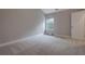 Neutral bedroom with a large window, door to the hall, and plush carpeting at 5414 Splendida Ct, Fairburn, GA 30213