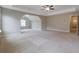 Large bedroom with tray ceiling and neutral carpet at 5414 Splendida Ct, Fairburn, GA 30213