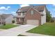 Charming two-story home with brick and siding, complemented by a lush lawn and a spacious driveway at 5414 Splendida Ct, Fairburn, GA 30213