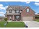 Charming two-story home featuring a brick and siding exterior with a well-manicured front yard at 5414 Splendida Ct, Fairburn, GA 30213