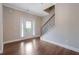 Bright foyer with hardwood floors, staircase, and large glass door allowing natural light to illuminate the space at 5414 Splendida Ct, Fairburn, GA 30213