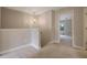 Upstairs hallway features an ornate hanging light, carpeted floor, and a view into a bedroom with a window at 5414 Splendida Ct, Fairburn, GA 30213