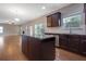 Kitchen with dark cabinets and stainless appliances open to living room at 5414 Splendida Ct, Fairburn, GA 30213
