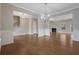 Spacious open-concept living room with hardwood floors, neutral paint, and multiple entryways at 5414 Splendida Ct, Fairburn, GA 30213