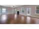 Bright living room with fireplace, wood floors, and plenty of natural light at 5414 Splendida Ct, Fairburn, GA 30213