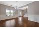 Open-concept living area with hardwood floors, wainscoting, a chandelier, and ample natural light at 5414 Splendida Ct, Fairburn, GA 30213