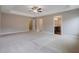 Large main bedroom featuring plush carpeting, neutral walls, and access to the main bathroom at 5414 Splendida Ct, Fairburn, GA 30213