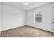 Bedroom with neutral carpeting and a window providing natural light, creating a serene living space at 5456 Union Hill Ct, Union City, GA 30291