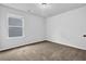 Bright bedroom featuring neutral walls, carpeted floors, and a window providing ample natural light at 5456 Union Hill Ct, Union City, GA 30291