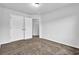 Bedroom featuring carpeted floors and white doors, providing a simple and clean living space at 5456 Union Hill Ct, Union City, GA 30291