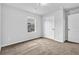 Carpeted bedroom featuring a window and white door, offering a simple and bright living space at 5456 Union Hill Ct, Union City, GA 30291