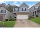 Charming two-story home with a brick and siding exterior and a two-car garage at 5456 Union Hill Ct, Union City, GA 30291