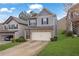 Two-story home with vinyl siding, brick accents, two-car garage, and a well-maintained lawn at 5456 Union Hill Ct, Union City, GA 30291