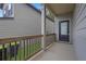 Inviting front porch with wood railing leading to a black front door at 5456 Union Hill Ct, Union City, GA 30291