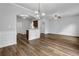 Open living room with hardwood floors, white wainscoting, and arched doorways at 5456 Union Hill Ct, Union City, GA 30291