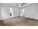 Spacious main bedroom featuring trey ceilings, carpet flooring, and access to a bathroom at 5456 Union Hill Ct, Union City, GA 30291