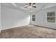 Spacious main bedroom featuring large windows, trey ceilings, and carpet flooring at 5456 Union Hill Ct, Union City, GA 30291