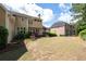 Large backyard with patio, mature trees and manicured lawn at 772 Vinings Estates Se Dr, Mableton, GA 30126