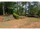 Picturesque backyard featuring terraced garden beds and a sprawling lawn at 772 Vinings Estates Se Dr, Mableton, GA 30126