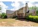 Spacious backyard featuring a wooden deck with pergola, manicured landscaping and ample green space at 772 Vinings Estates Se Dr, Mableton, GA 30126