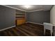 Unfinished basement area with wood-look flooring, storage cabinet and utility sink at 772 Vinings Estates Se Dr, Mableton, GA 30126