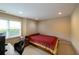 Cozy bedroom features a bed, a window, and a dedicated computer area at 772 Vinings Estates Se Dr, Mableton, GA 30126