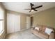 Bright bedroom with a ceiling fan, plush carpeting, and ample closet space at 772 Vinings Estates Se Dr, Mableton, GA 30126