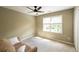 Inviting bedroom featuring neutral tones, a ceiling fan, and a cozy sitting area at 772 Vinings Estates Se Dr, Mableton, GA 30126